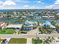 An aerial view of a canal front home showcasing its waterfront location and neighborhood at 525 68Th St St, Holmes Beach, FL 34217