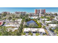 Real estate aerial view of houses, water feature, ocean, and buildings at 534 Sutton Pl, Longboat Key, FL 34228
