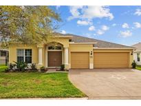 Charming single-story home with a three-car garage and well-manicured lawn at 5342 98Th E Ave, Parrish, FL 34219
