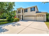 Beautiful two-story home boasts a three-car garage and manicured landscaping at 6156 41St E St, Bradenton, FL 34203