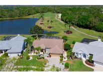 Stunning aerial view of home overlooking the golf course, lake, and lush landscaping at 6511 Turners Gap Rd, Bradenton, FL 34203