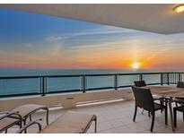 Outdoor seating on a spacious balcony with a stunning ocean view at sunset at 655 Longboat Club Rd # 16B, Longboat Key, FL 34228