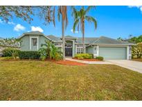 Charming single-story home with a well-manicured lawn and lush landscaping, creating curb appeal at 7604 49Th E Ave, Bradenton, FL 34203
