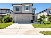 Charming two-story home features a spacious driveway and an attached two-car garage at 8262 Velda Trl, Sarasota, FL 34241