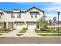 Charming townhome featuring an attached garage, neutral paint, and neatly landscaped front yard at 2718 Chestnut Creek Pl, Brandon, FL 33510