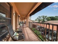 Spacious balcony featuring comfortable seating and views of the community parking area at 2808 60Th W Ave # 1722, Bradenton, FL 34207