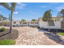 Charming single-story home featuring a well-manicured lawn and a welcoming brick driveway at 317 Gulf Dr, Venice, FL 34285