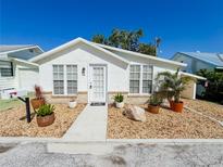 Charming single-story home featuring well-manicured landscaping and a welcoming front entrance at 4 Braden Castle Dr, Bradenton, FL 34208