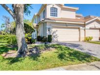 Two-story home featuring a two car garage, terracotta roof, and a well-maintained landscaped yard at 4480 Cinnamon Dr # 2408, Sarasota, FL 34238