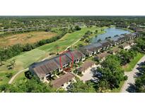 Beautiful aerial view of a condo community, golf course and lake at 5211 Mahogany Run # 113, Sarasota, FL 34241