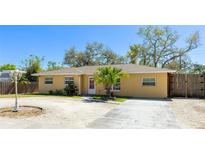 Charming single-story home with a well-maintained yard and a concrete driveway at 5562 Hayden Blvd, Sarasota, FL 34232