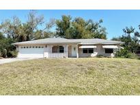 Charming single-story home with well-maintained lawn and covered front porch at 6924 Tuxedo St, Englewood, FL 34224