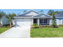 Charming single-story home with a two-car garage, manicured lawn, and inviting curb appeal at 818 170Th E Ct, Bradenton, FL 34212