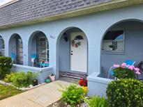 Charming home with a welcoming front porch, arched entryways, and vibrant landscaping at 3807 41St Street W Ct # 52, Bradenton, FL 34205