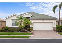 Charming single-story home featuring a well-maintained lawn, tile roof and a two-car garage at 2183 Nettlebush Ln, Venice, FL 34292