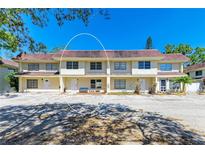 Inviting townhome with well-kept landscaping, neutral colors, and parking area at 3717 Delta St # 95, Sarasota, FL 34232