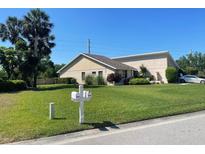 A charming single story home with a lush green lawn and mature landscaping at 3799 Countryside Rd, Sarasota, FL 34233