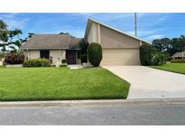 Charming single-Gathering home with a manicured lawn, mature landscaping, and a two-car garage at 3799 Countryside Rd, Sarasota, FL 34233