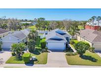 Charming single-story home with a well-manicured lawn and mature landscaping, complemented by a driveway and attached garage at 5234 Aqua Breeze Dr, Bradenton, FL 34208