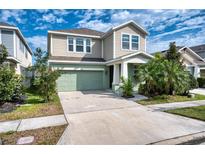Charming two-story home with a well-manicured lawn and attached two-car garage at 6136 Voyagers Pl, Apollo Beach, FL 33572