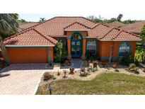 Inviting single-story home featuring terra cotta roofing and a well-manicured front yard at 7118 42Nd E Ct, Sarasota, FL 34243