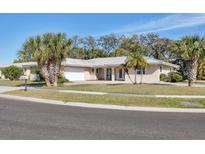 Beautiful single-story home with a well-manicured lawn and mature landscaping at 7211 Antigua Pl, Sarasota, FL 34231