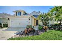 Charming home featuring a well-manicured lawn and a two-car garage, with inviting curb appeal at 7424 Ridgelake Cir, Bradenton, FL 34203