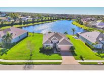 Beautiful single-Gathering home with manicured lawn overlooking a serene lake in a peaceful neighborhood at 1014 Calico Gln, Bradenton, FL 34212