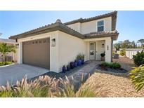 Charming two-story home with well-manicured landscaping and a paved walkway to the front door at 1876 Livingstone St, Sarasota, FL 34231