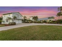 Inviting two story coastal home with lush landscaping, a circular driveway, and a two car garage at 336 S Orchid Dr, Ellenton, FL 34222