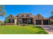 Charming single-Gathering home featuring a manicured lawn, stone accents, dormer windows and a brick-paved driveway at 3712 59Th Avenue E Cir, Ellenton, FL 34222