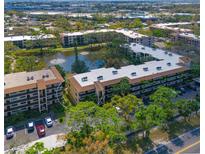 An aerial view of condos surrounded by lush trees and water features in a beautiful community at 425 30Th W Ave # C201, Bradenton, FL 34205