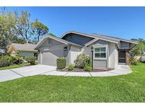 Charming single-story home featuring well-maintained landscaping and an attached garage, inviting curb appeal at 7767 Pine Trace Dr, Sarasota, FL 34243