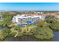 Stunning aerial view of complex surrounded by lush greenery and serene waters at 835 S Osprey Ave # 101, Sarasota, FL 34236