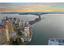 Stunning aerial view of condo building near the beach with a picturesque bay view at sunset at 101 Sunset Dr # 103, Sarasota, FL 34236