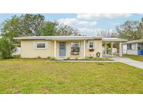 Charming single-story home featuring a well-maintained lawn, carport, and neutral-toned facade at 108 21St Ne St, Bradenton, FL 34208