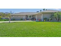 Well-maintained lawn leading up to a charming single-story home at 1208 Angela Maria Rd, Sarasota, FL 34243