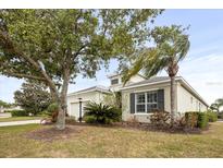 Charming single-story home with a well-manicured front yard, mature trees and attached garage at 4691 Claremont Park Dr, Bradenton, FL 34211