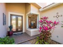 Elegant front entrance with double doors, brick walkway, and lush landscaping providing great curb appeal at 4740 Carrington Cir, Sarasota, FL 34243