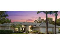 Charming single-story home with a well-manicured lawn, mature landscaping, and a neutral color palette at 7300 Wax Myrtle Way, Sarasota, FL 34241