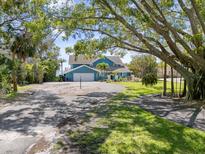 Beautiful waterfront home with an attached two-car garage and circular driveway at 7330 Westmoreland Dr, Sarasota, FL 34243