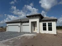 Charming single-story home featuring a three-car garage, neutral paint scheme, and tile roof at 7561 Nighthawk Dr, Sarasota, FL 34241