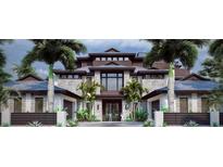 Stunning new construction, multi-story home featuring a stone facade, modern architectural design, and lush tropical landscaping at 821 S Bay Blvd, Anna Maria, FL 34216