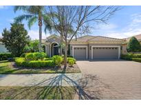 Charming single-story home with well-manicured landscaping and a three-car garage, perfect for curb appeal at 15508 Leven Links Pl, Lakewood Ranch, FL 34202