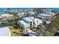 Waterfront condo building with boat access and luxurious tropical landscaping near the canal at 4104 128Th W St # 704, Cortez, FL 34215