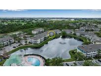Beautiful aerial view of condo community surrounding a pond and lush greenery at 4802 51St W St # 1714, Bradenton, FL 34210