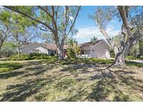 Charming single-story home with lush landscaping and mature trees, offering a serene and private setting at 4965 Marsh Field Rd, Sarasota, FL 34235