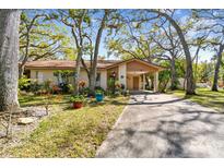 Charming single-story home featuring a carport, neutral paint, mature trees, and well-manicured landscaping at 5117 27Th W St # 5117, Bradenton, FL 34207
