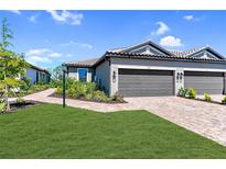 Charming one-story home featuring a two-car garage, landscaped front yard, and welcoming entryway at 6179 Mesa Gln, Bradenton, FL 34203