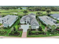 Stunning aerial view of luxury home, lush landscaping, and golf course at 8847 Colonels Ct, Sarasota, FL 34240